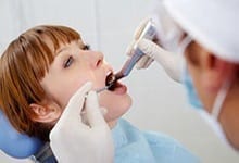 Dentist performing dental work on patient
